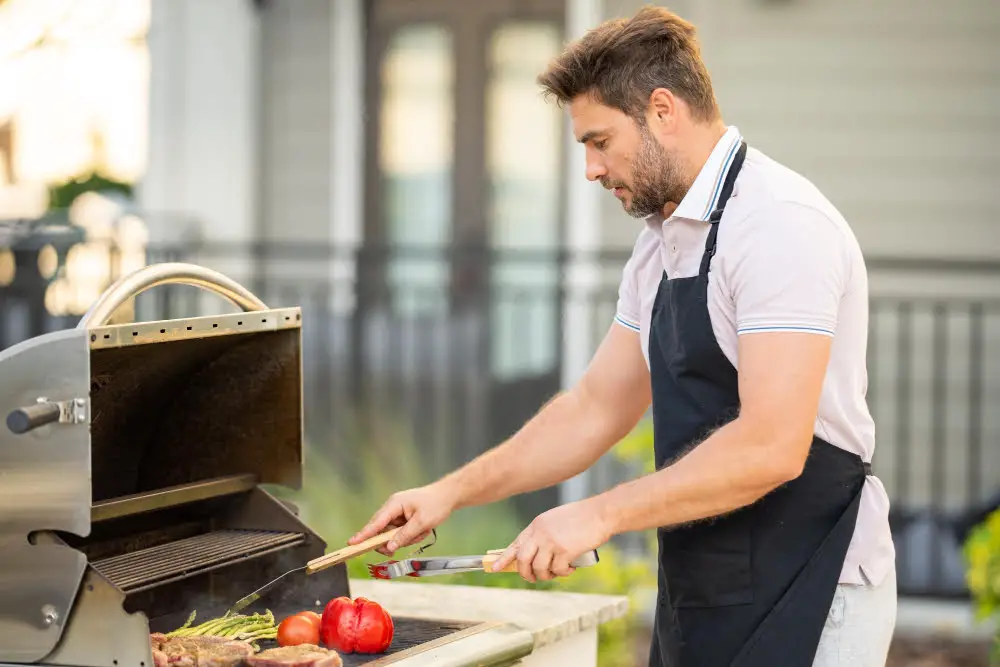 man checking time grilling