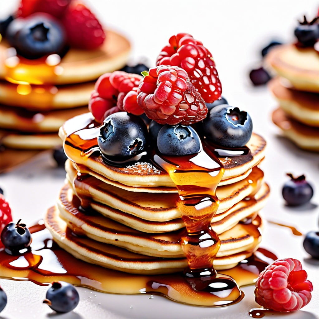 mini pancake stacks with berries and honey