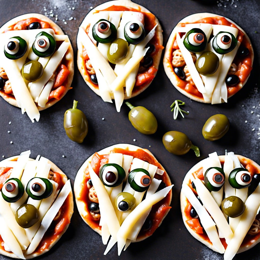 mummy mini pizzas use string cheese for the bandages and olives for the eyes