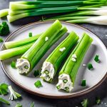 celery sticks filled with green cream cheese and sprinkled with green onions