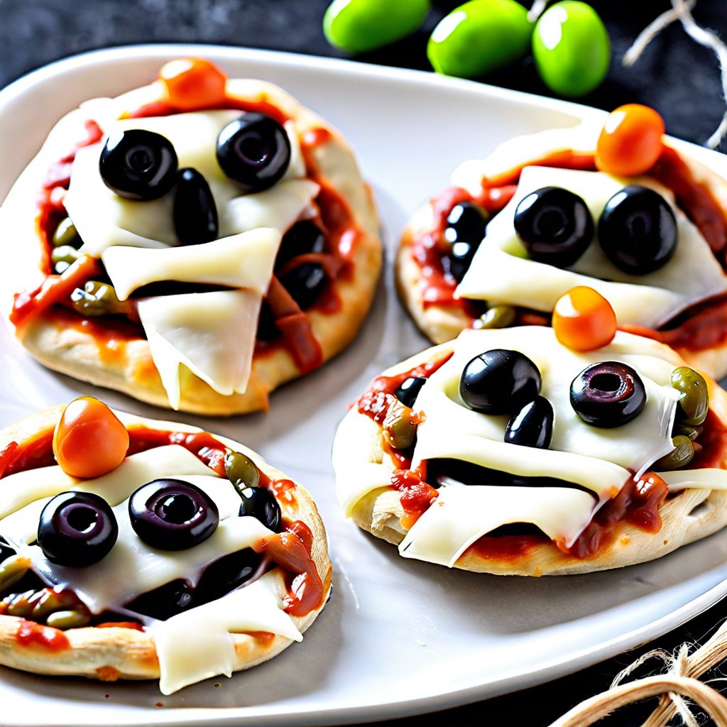 mini mummy pizzas with olives and string cheese